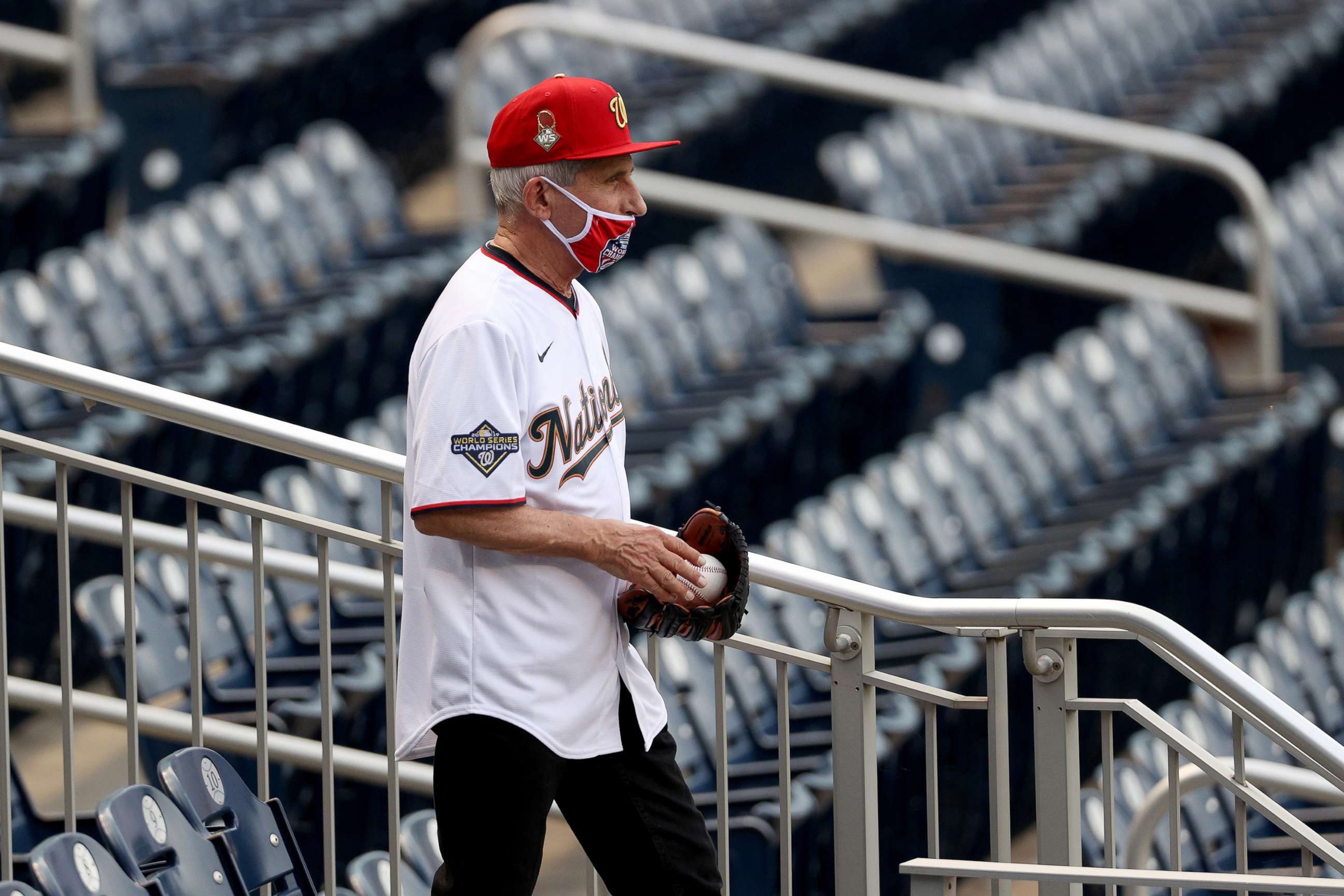 PHOTO: Dr. Anthony Fauci, director of the National Institute of Allergy and Infectious Diseases walks to the field to throw out the ceremonial first pitch.