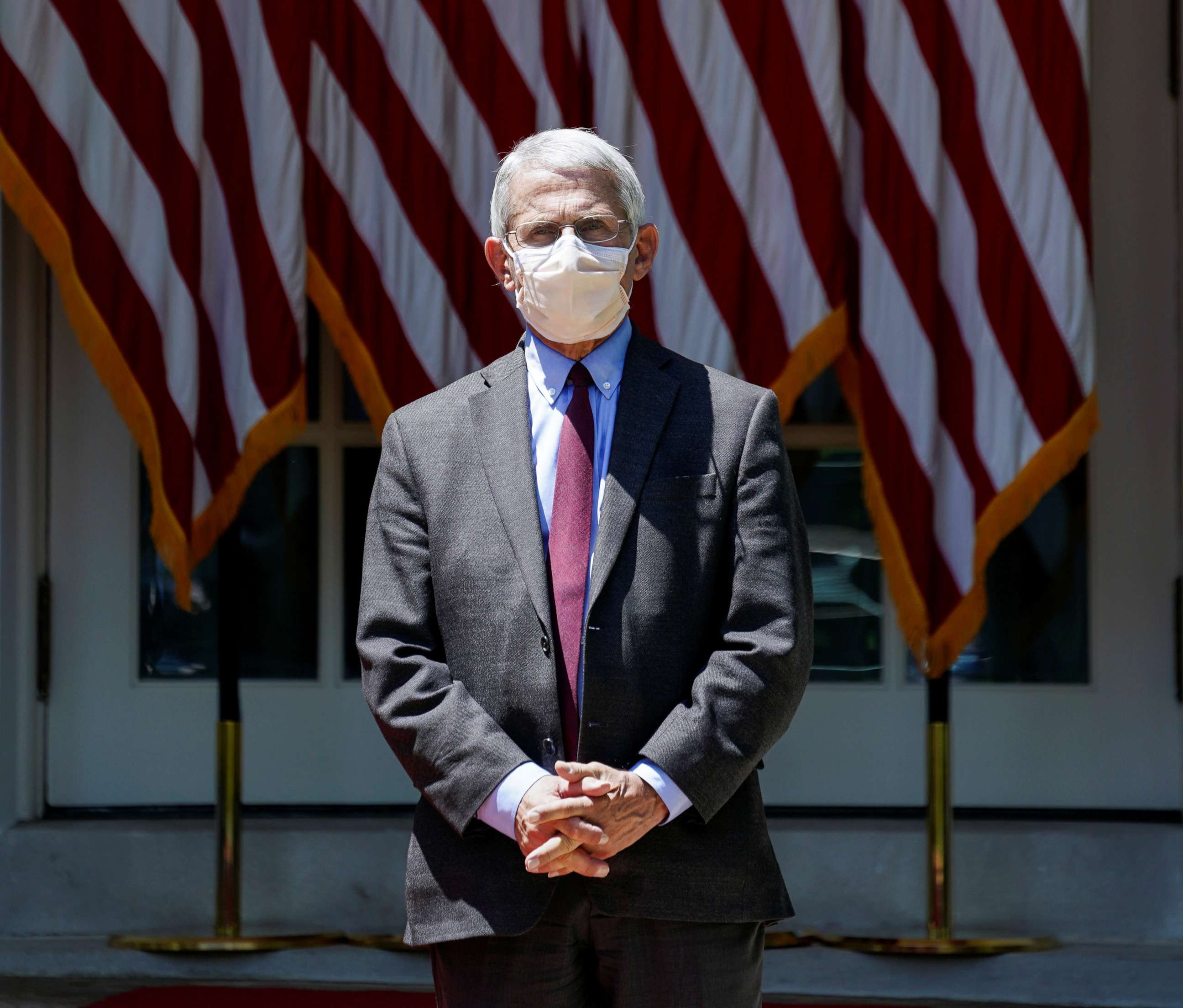 PHOTO: National Institute of Allergy and Infectious Diseases Director Dr. Anthony Fauci listens as President Donald Trump speaks about administration efforts to develop a coronavirus vaccine in the Rose Garden of the White House, May 15, 2020.