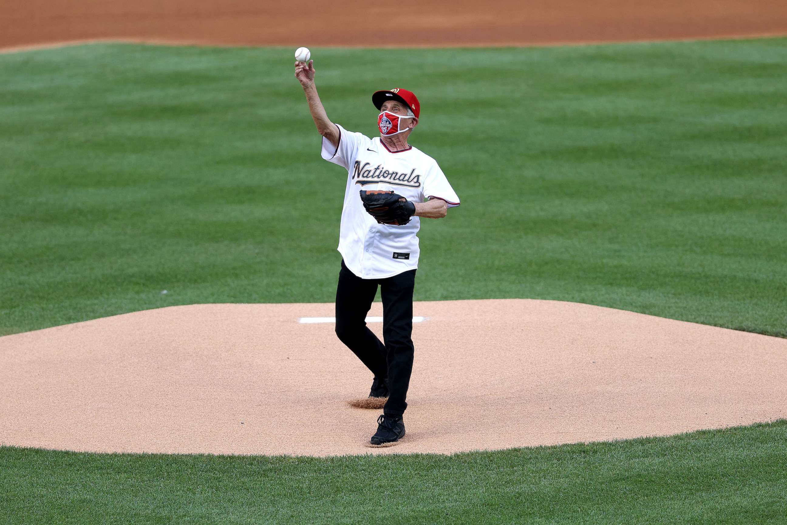 PHOTO: Dr. Anthony Fauci, director of the National Institute of Allergy and Infectious Diseases throws out the ceremonial first pitch.