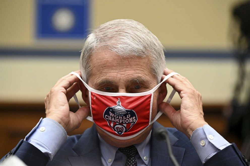 PHOTO: Anthony Fauci, director of the National Institute of Allergy and Infectious Diseases, removes his Washington Nationals protective mask during a House Select Subcommittee on the Coronavirus Crisis hearing on July 31, 2020, in Washington, D.C.