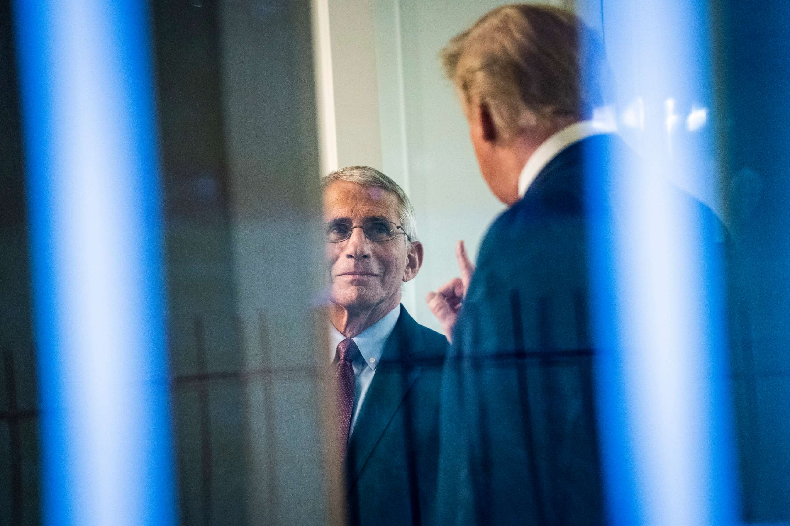PHOTO: President Donald J. Trump speaks with Dr. Anthony Fauci in the press office moments after speaking with members of the coronavirus task force during a briefing in response to the COVID-19 coronavirus pandemic, April 22, 2020, in Washington, DC.