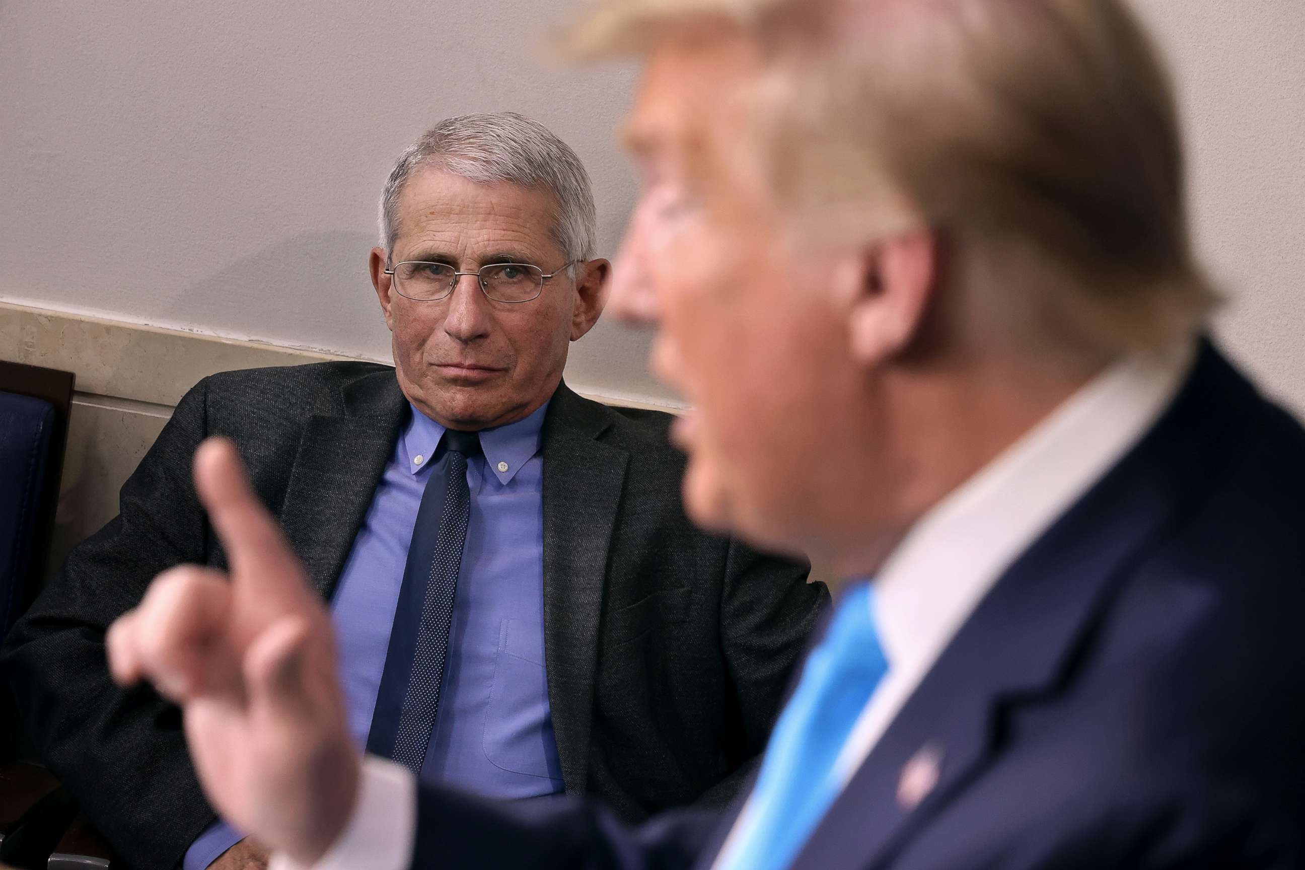 PHOTO: Anthony Fauci, director of the National Institute of Allergy and Infectious Diseases, listens to President Donald Trump speak to reporters in the Brady Press Briefing Room at the White House, April 7, 2020.