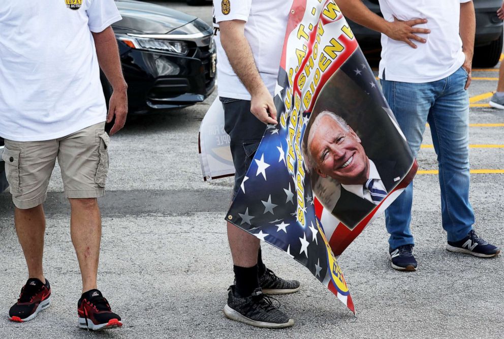 PHOTO: A union worker holds a banner depicting a picture of Democratic presidential nominee Joe Biden in a caravan for Biden in Miami Springs, Fla., Oct. 11, 2020.