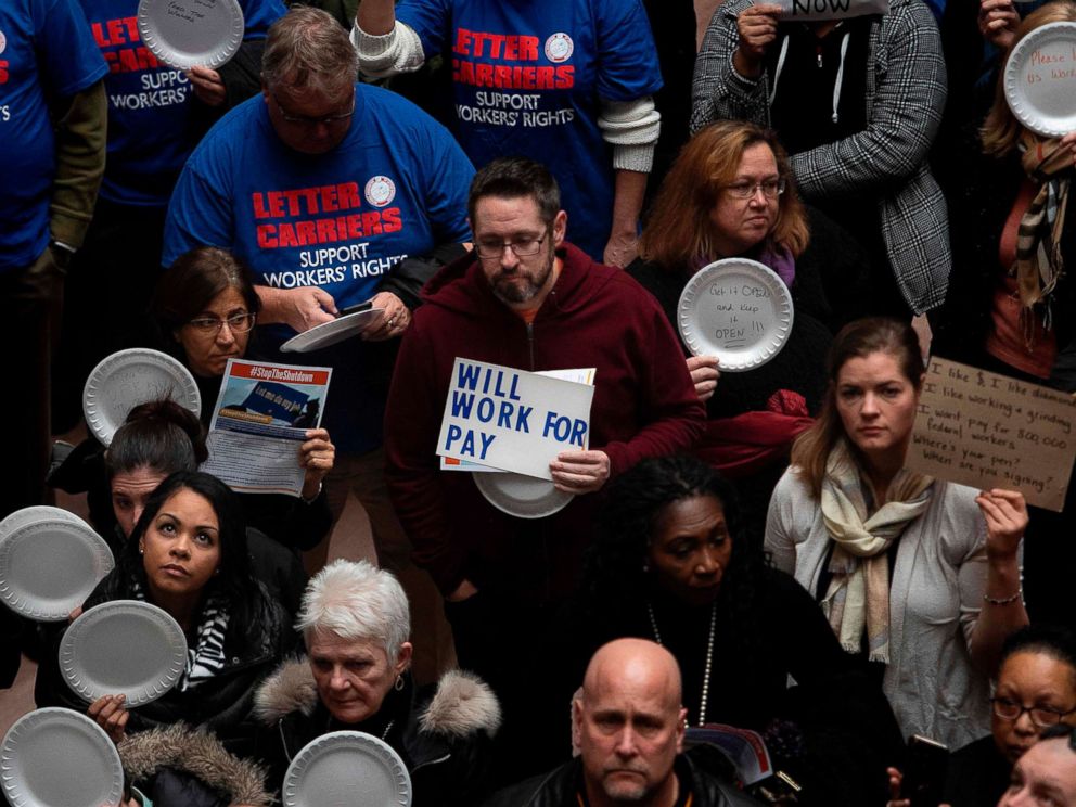 PHOTO: A federal worker stands with a placard reading Will Work For Pay as other federal employees stage a rally to call for a vote on the shutdown on Capitol Hill in Washington, Jan. 23, 2019.