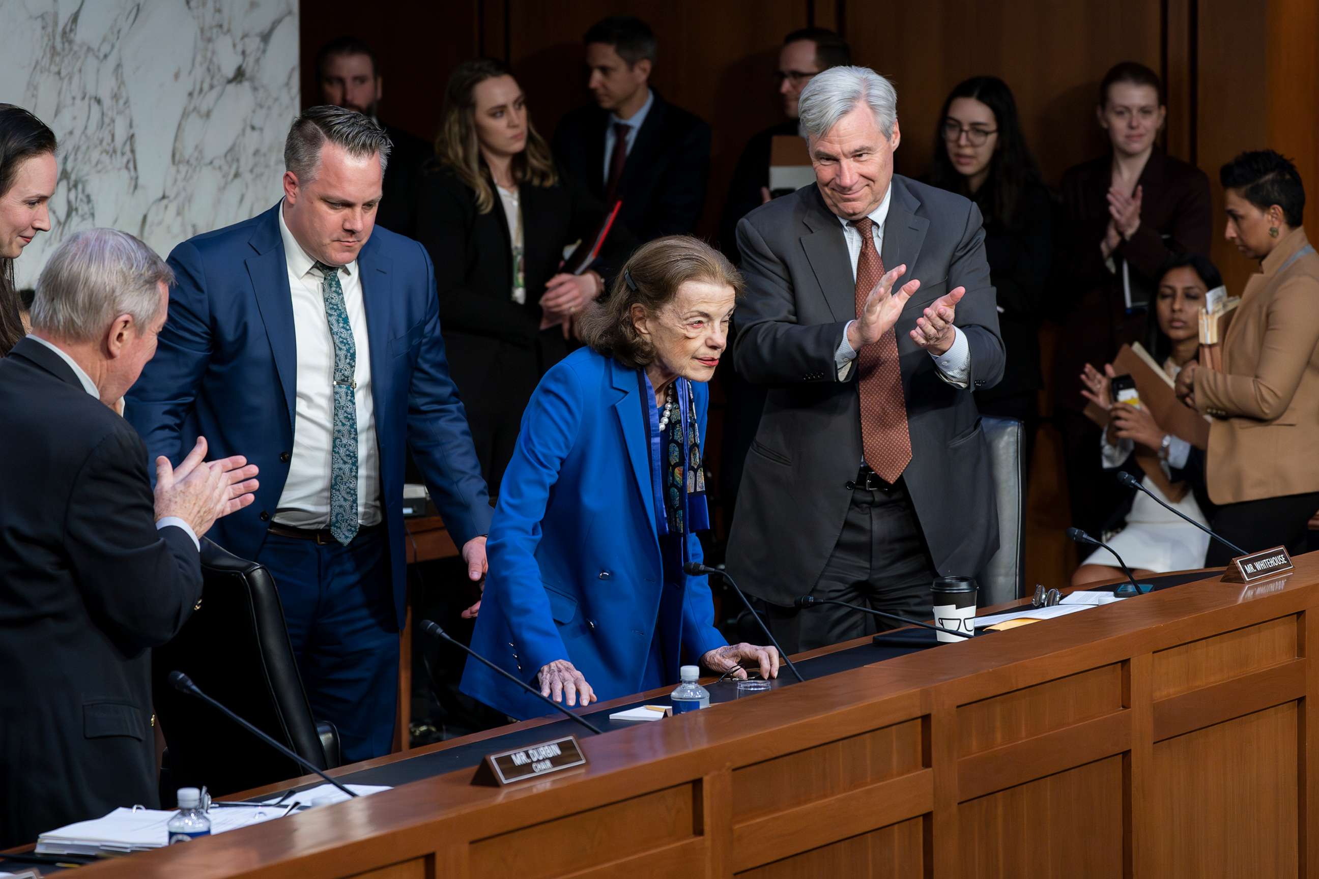 PHOTO: Sen. Dianne Feinstein is welcomed back to the Senate Judiciary Committee with applause from Senate Judiciary Committee Chairman Dick Durbin, left, and Sen. Sheldon Whitehouse, right, following a more than two-month absence, May 11, 2023.