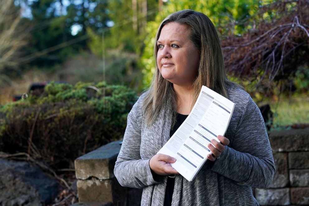 PHOTO: Rep. Tarra Simmons poses with blank voter registration forms at her home in Bremerton, Wash., Dec. 9, 2020.