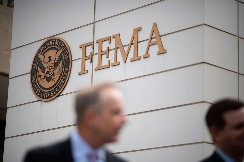 PHOTO: People walk in front of the Federal Emergency Management Agency logo at the FEMA headquarters in Washington, on Sept. 9, 2019.