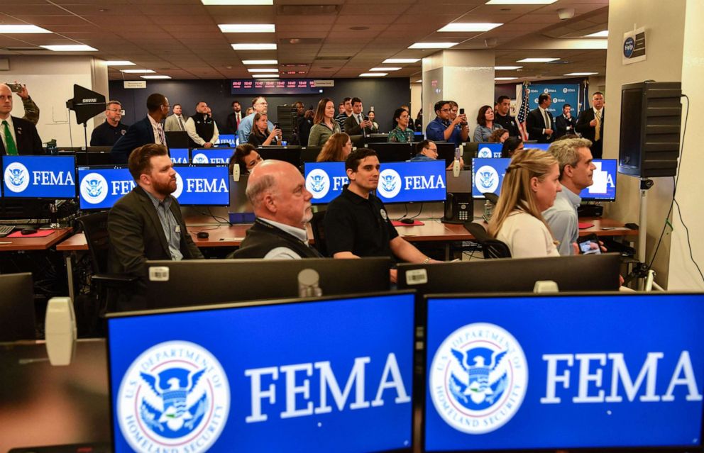 PHOTO: Members of FEMA look on as President Joe Biden speaks during a briefing at FEMA headquarters on May 24, 2021, in Washington.