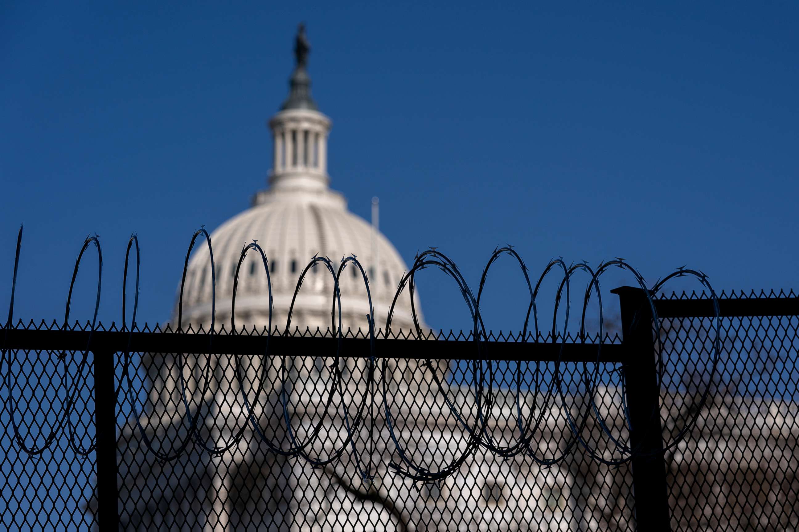 PHOTO: Barbed wire is installed on security fencing surrounding the U.S. Capitol, Jan. 14, 2021, in Washington, D.C. 