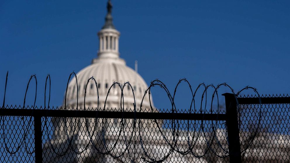 PHOTO: Barbed wire is installed on security fencing surrounding the U.S. Capitol, Jan. 14, 2021, in Washington, D.C. 