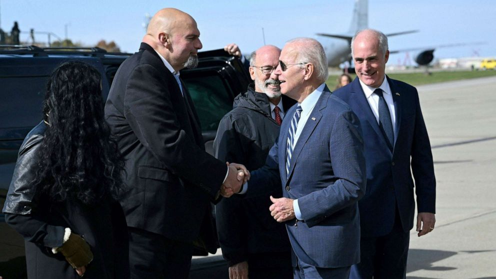 PHOTO: President Joe Biden is greeted by Pennsylvania Lieutenant Governor John Fetterman after disembarking Air Force One at Philadelphia International Airport in Philadelphia, Pennsylvania, on October 20, 2022.