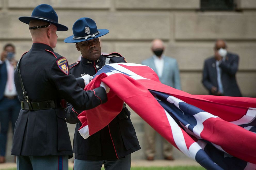 PHOTO: Members of the Mississippi Highway Safety Patrol Honor Guard retire the state flag outside the Mississippi State Capitol building in Jackson, Mississippi on July 1, 2020.