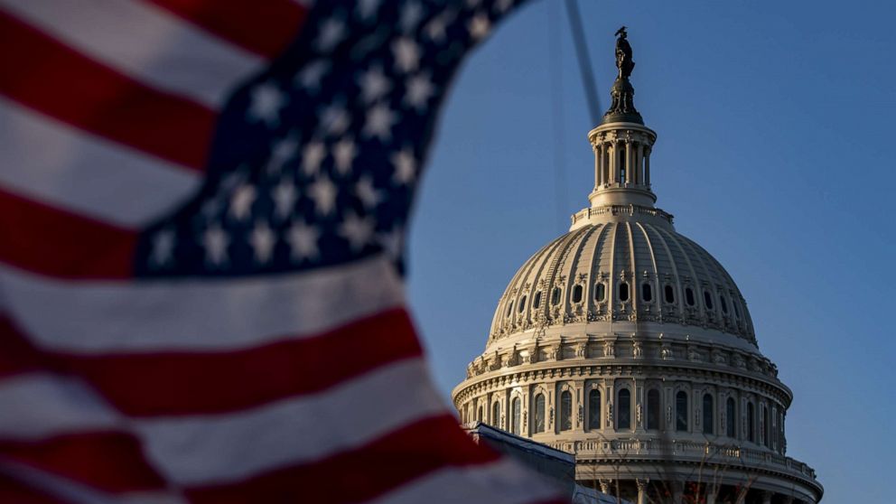 PHOTO: A U.S. flag flies near the dome of the U.S. Capitol while the House of Representatives debates two articles of impeachment against President Donald Trump on Dec. 18, 2019, in Washington.