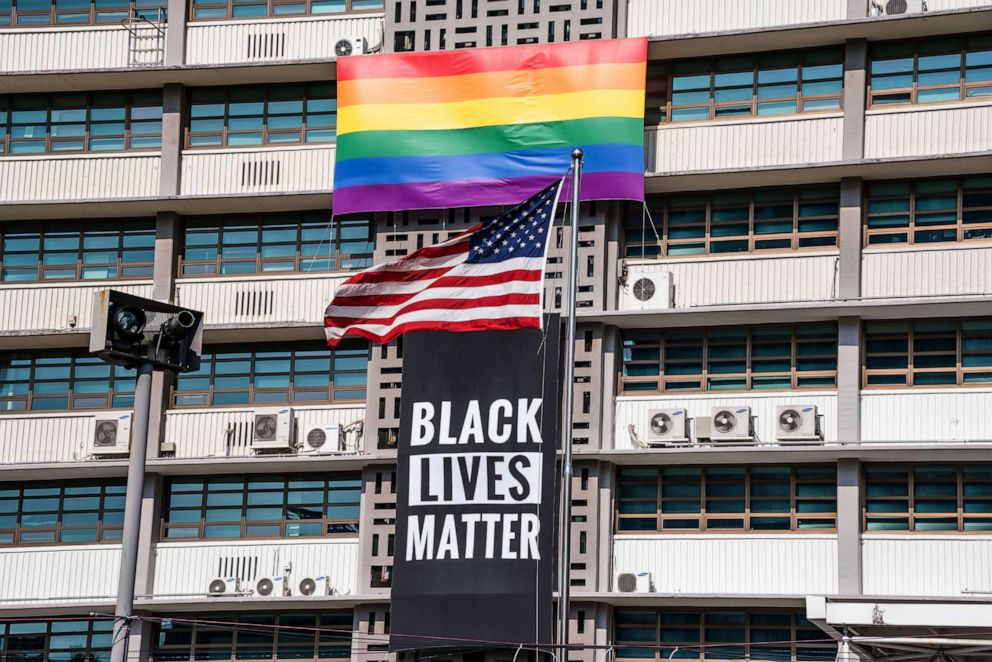 PHOTO: A Black Lives Matter banner, a United States national flag and a rainbow flag are hung on the facade of the US embassy building in Seoul, June 14, 2020.
