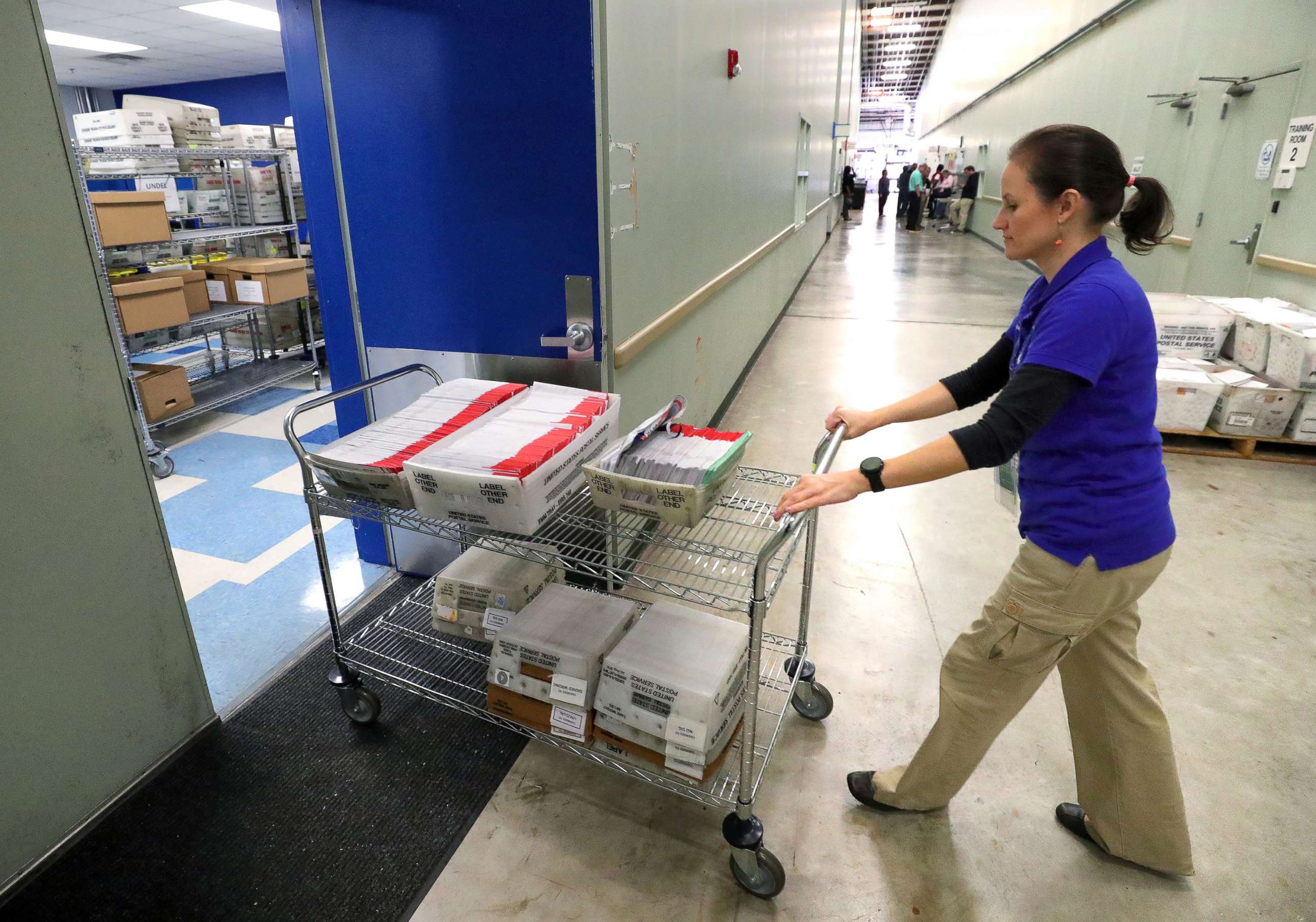 PHOTO: A worker delivers mail-in ballots for processing at the Orange County Supervisor of Elections office in Orlando, Fla. for the Florida primary, on March 17, 2020.
