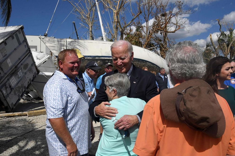 PHOTO: President Joe Biden hugs a local resident impacted by Hurricane Ian at Fishermans Wharf in Fort Myers, Fla., Oct. 5, 2022.