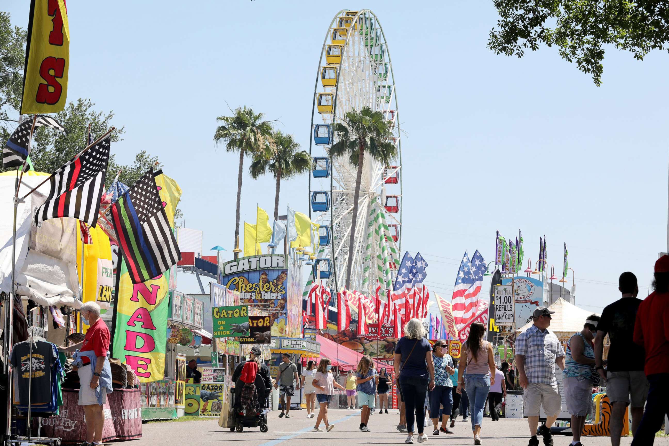 PHOTO: Visitors to the 2021 Florida State Fair tour a row of concessions and venders on opening day, April 22, 2021, at the Florida State Fairgrounds in Tampa, Fla.