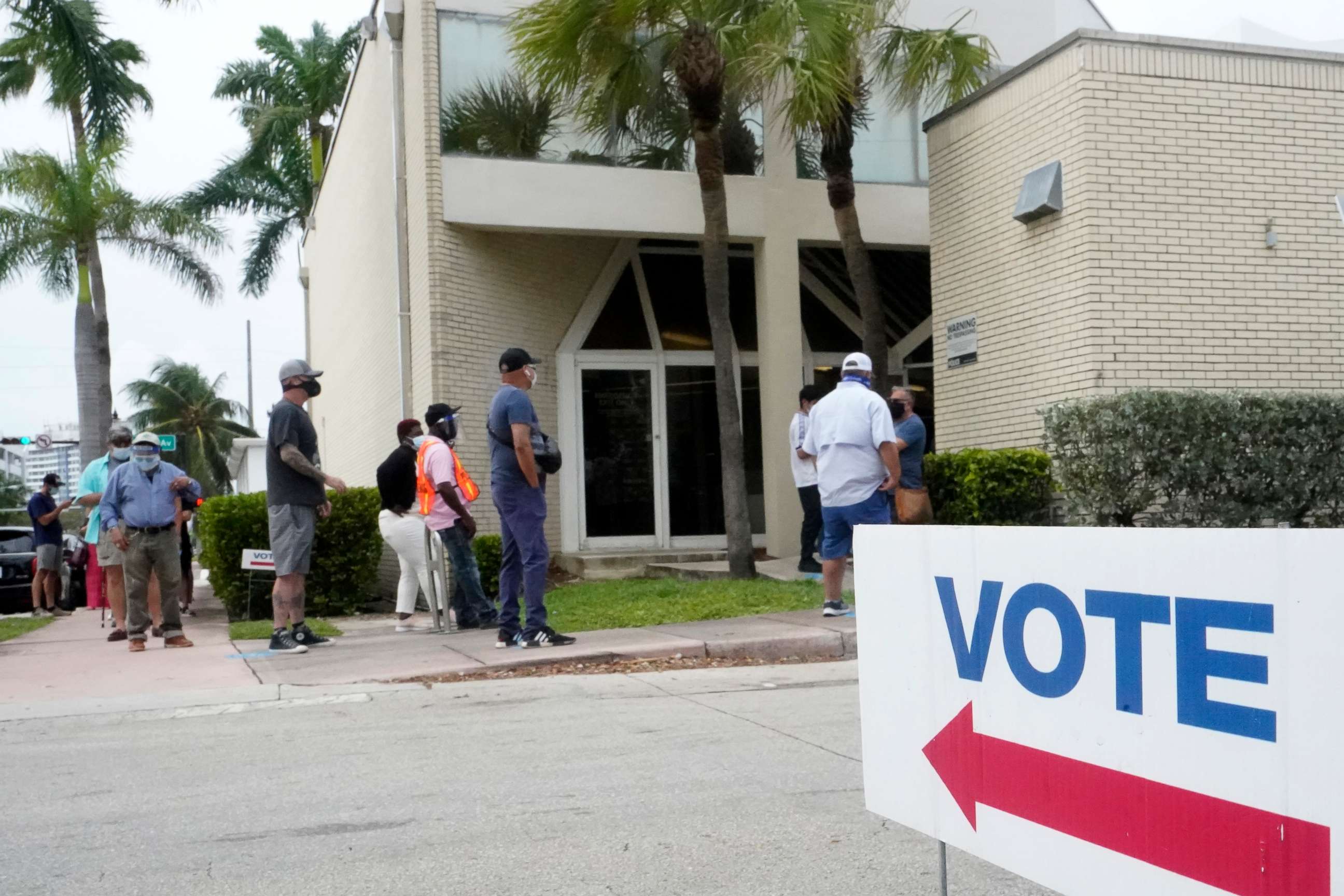 PHOTO: People wait in line to vote outside of an early voting site, Oct. 20, 2020, in Miami Beach, Fla.