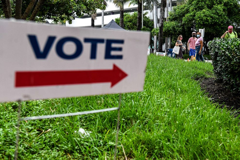 PHOTO: Voters wait in line to cast their early ballots at Miami Beach City Hall in Miami Beach, Florida, Oct. 20, 2020.