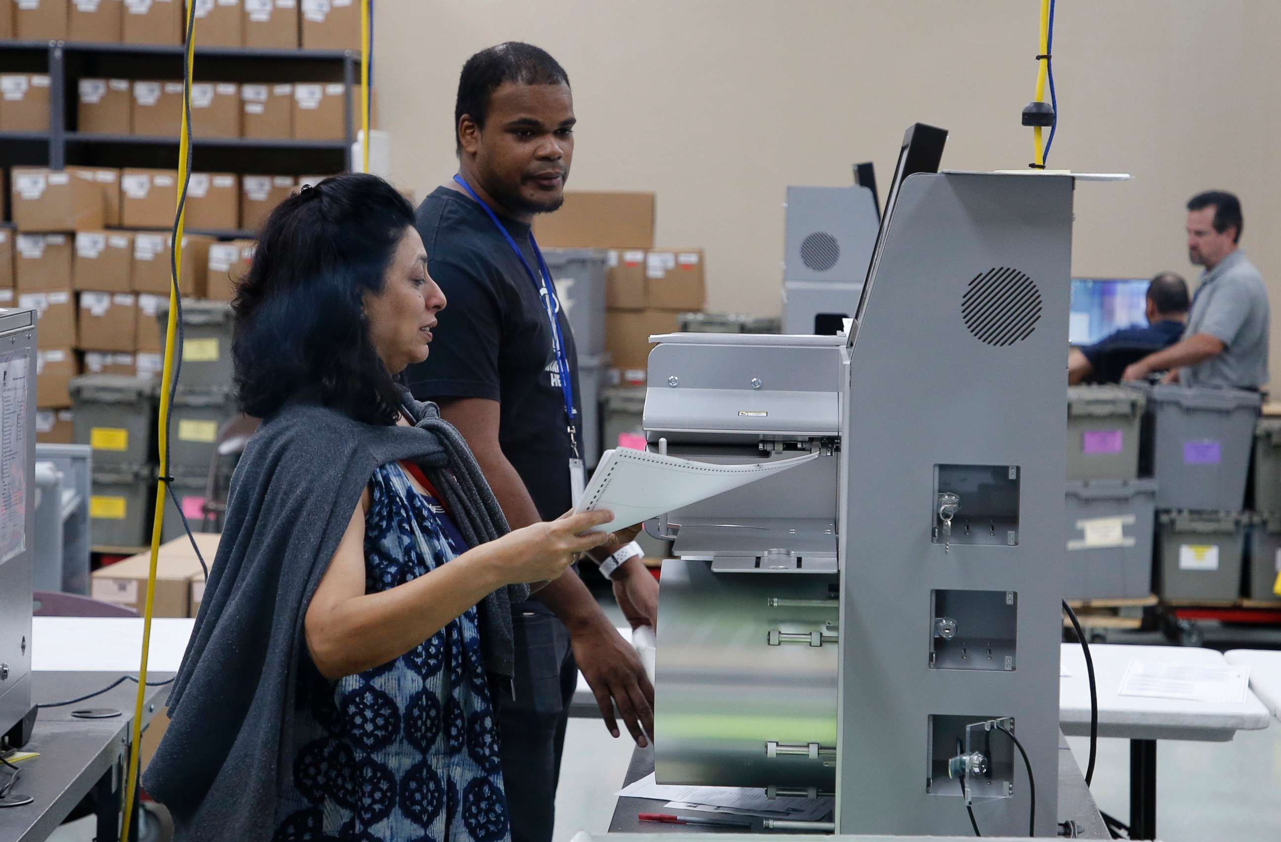 PHOTO: An elections worker feeds ballots into a tabulation machine at the Broward County Supervisor of Elections office on Nov. 10, 2018 in Lauderhill, Fla.