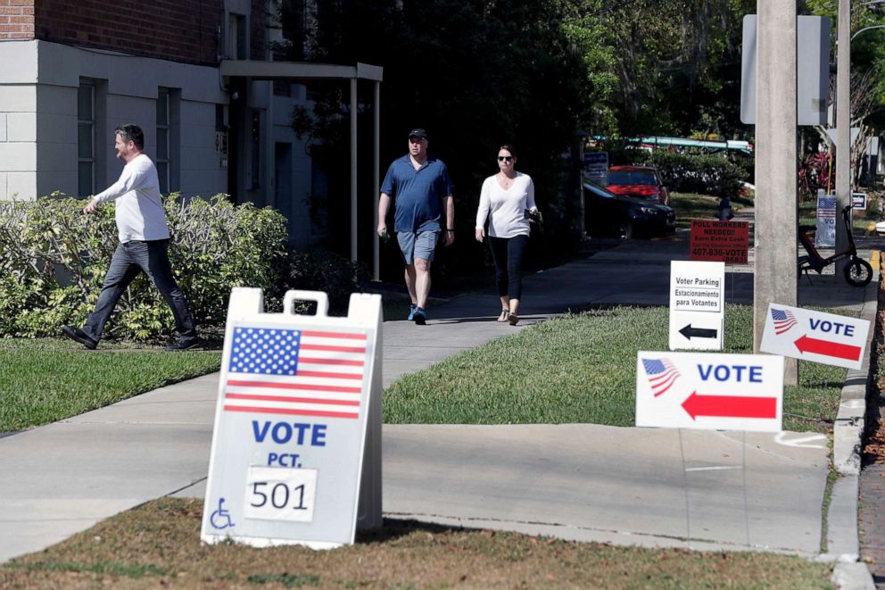 PHOTO: Voters head to a polling station to vote in Florida's primary election in Orlando, Fla., March 17, 2020.