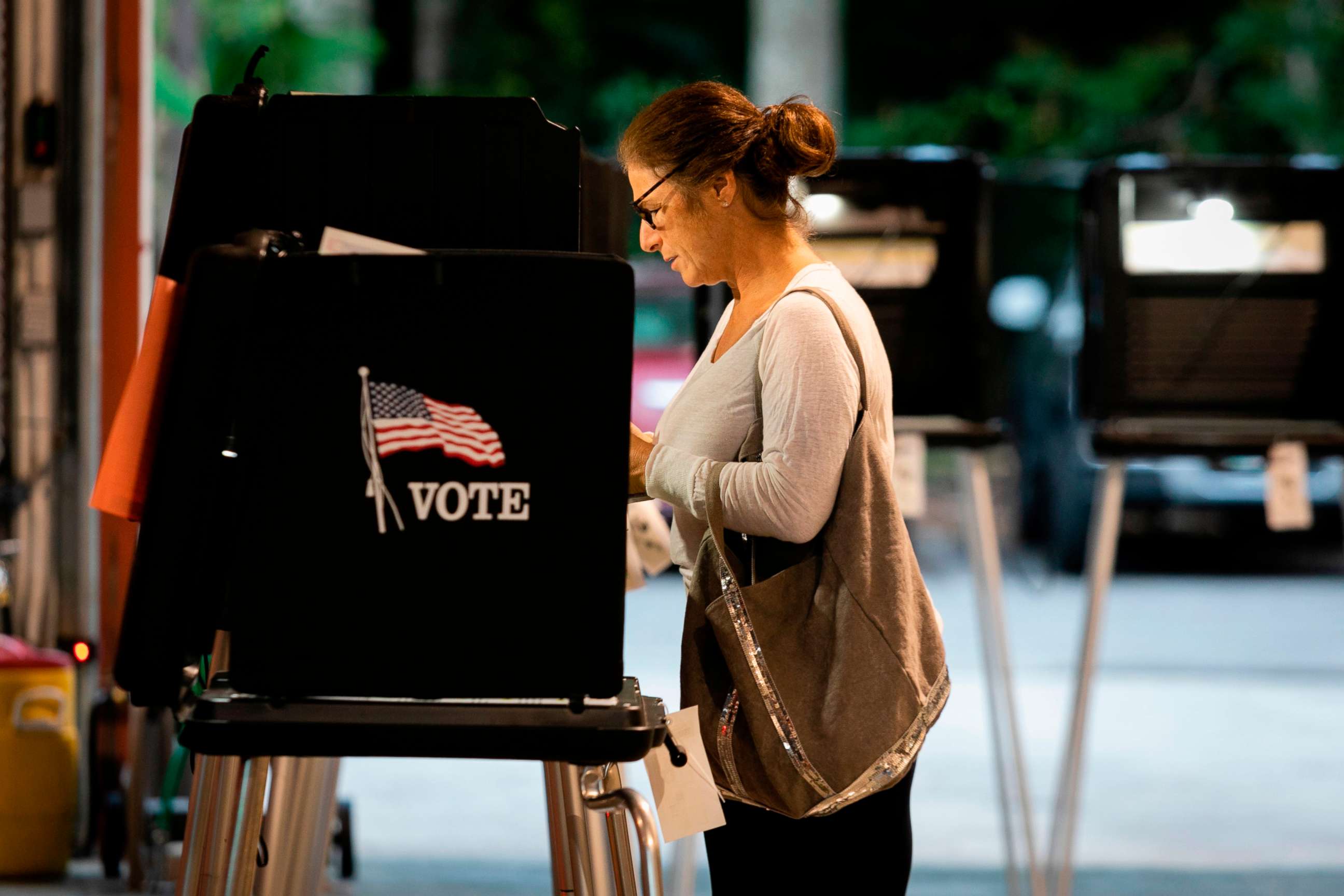 PHOTO: A woman casts her vote during the Florida primary election at Doris &  Phil Sanford Fire Rescue Station Coral Gables in Miami, on March 17, 2020.