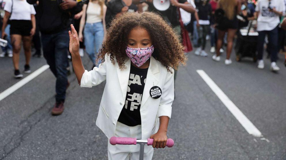 PHOTO: A child participates in a demonstration on the first anniversary of the death of George Floyd, in the Brooklyn borough of New York, May 25, 2021. 