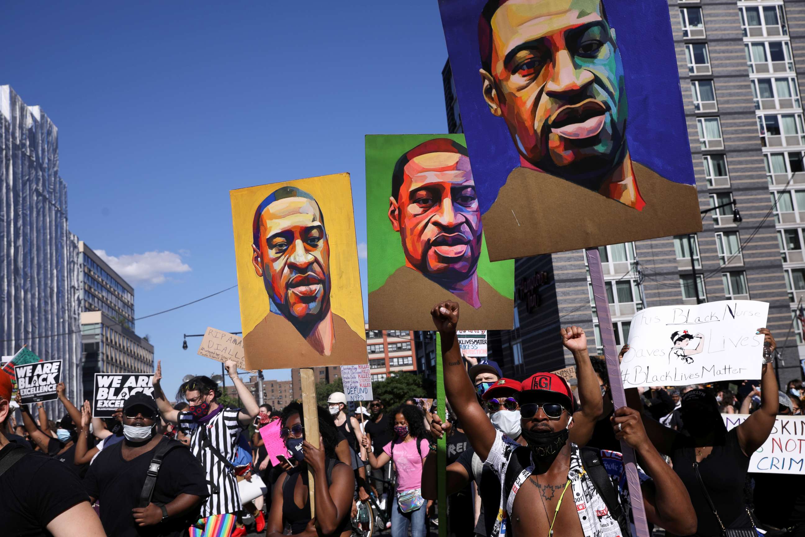 PHOTO: Demonstrators hold signs depicting George Floyd, who died in Minneapolis police custody, during a protest against police brutality and racial inequality in Brooklyn, New York, June 13, 2020.