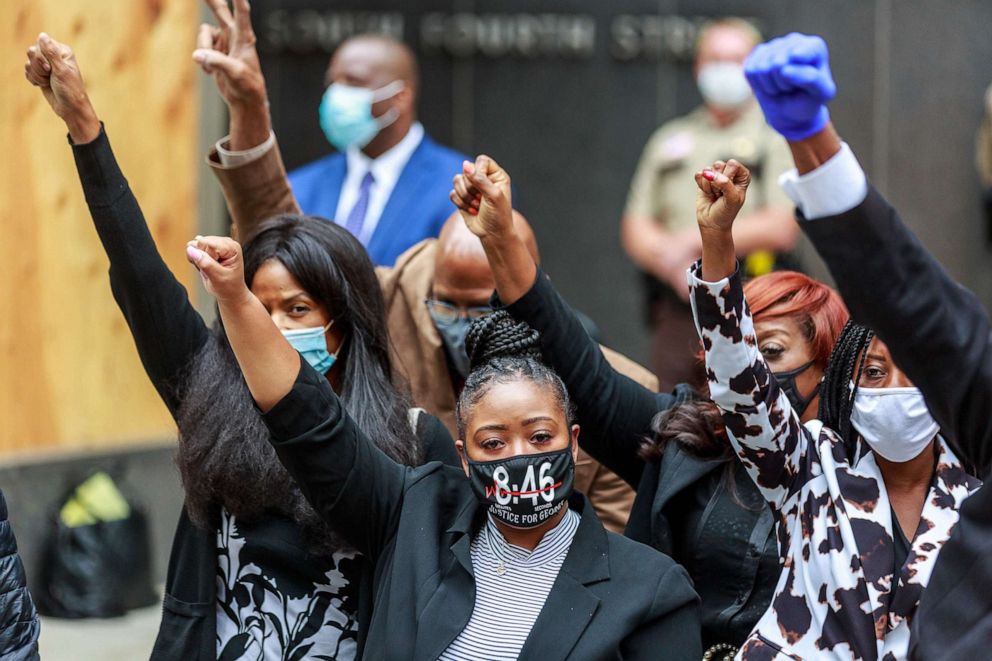 PHOTO: George Floyd's family raise their hands during a press conference after a court hearing on the murder of George Floyd in Minneapolis, Sept. 11, 2020.  