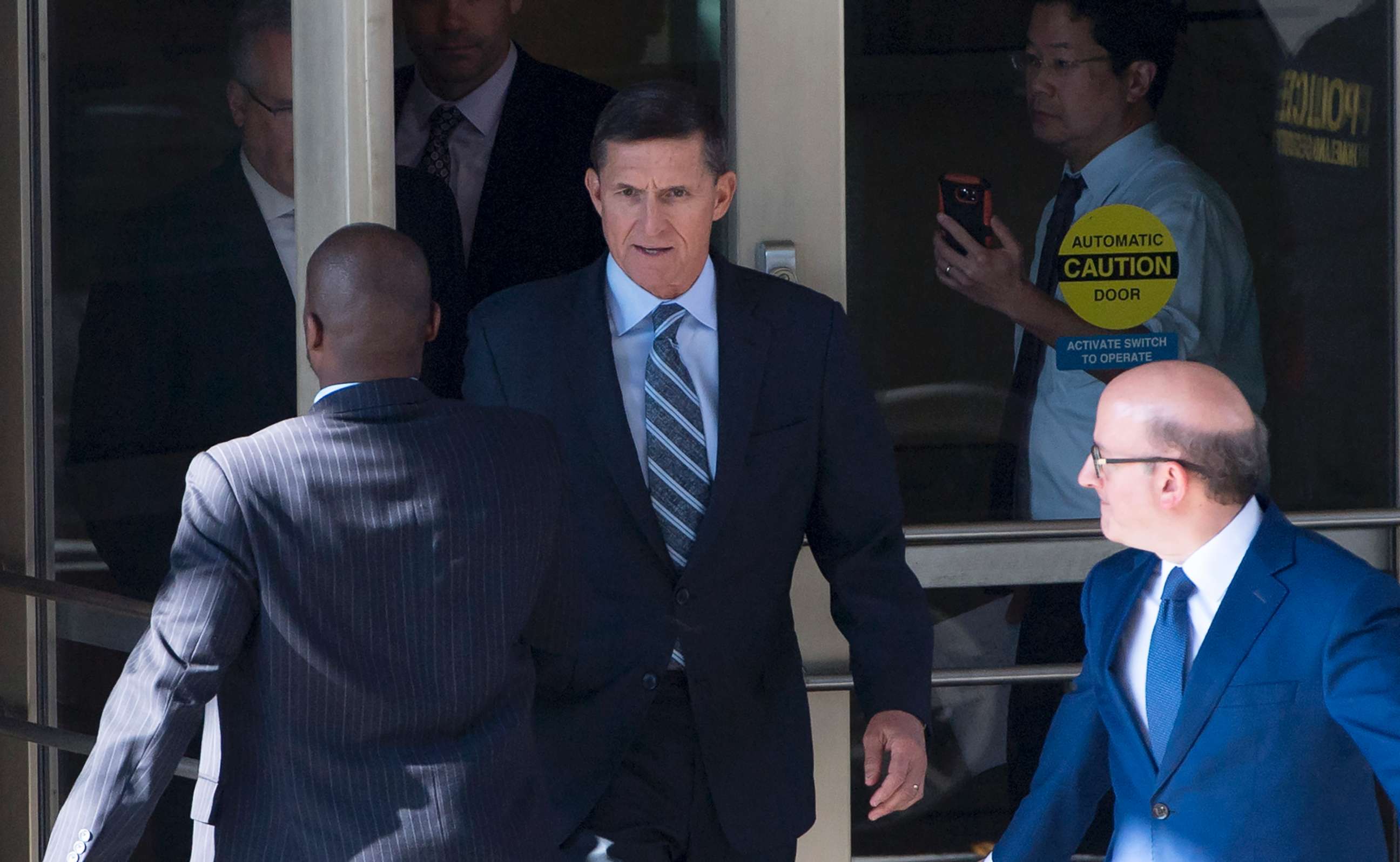 PHOTO: Gen. Michael Flynn, center, with his attorney, Robert Kelner, right, leaves Federal Court in Washington, DC, December 1, 2017 after pleading guilty to one count of lying to the FBI about his back-channel negotiations with the Russian ambassador.