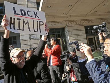 PHOTO: A handful of demonstrators held signs outside the Federal Courthouse where Michael Flynn, former national security adviser to President Donald Trump, had his plea hearing December 1, 2017 in Washington, DC.