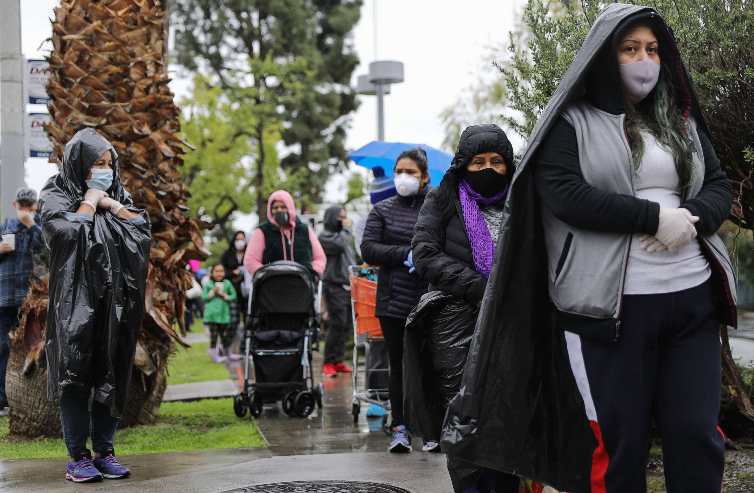 PHOTO: In this April 9, 2020, file photo, people wait in line to receive food at a Food Bank distribution for those in need in Van Nuys, Calif.