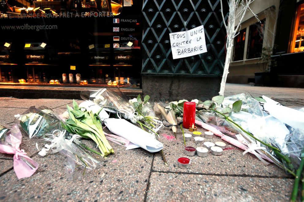 PHOTO: Candles, flowers and a sign reading  'All united against barbarity' are left where a person was killed during the Christmas Market shooting in Strasbourg, France, Dec. 12, 2018.