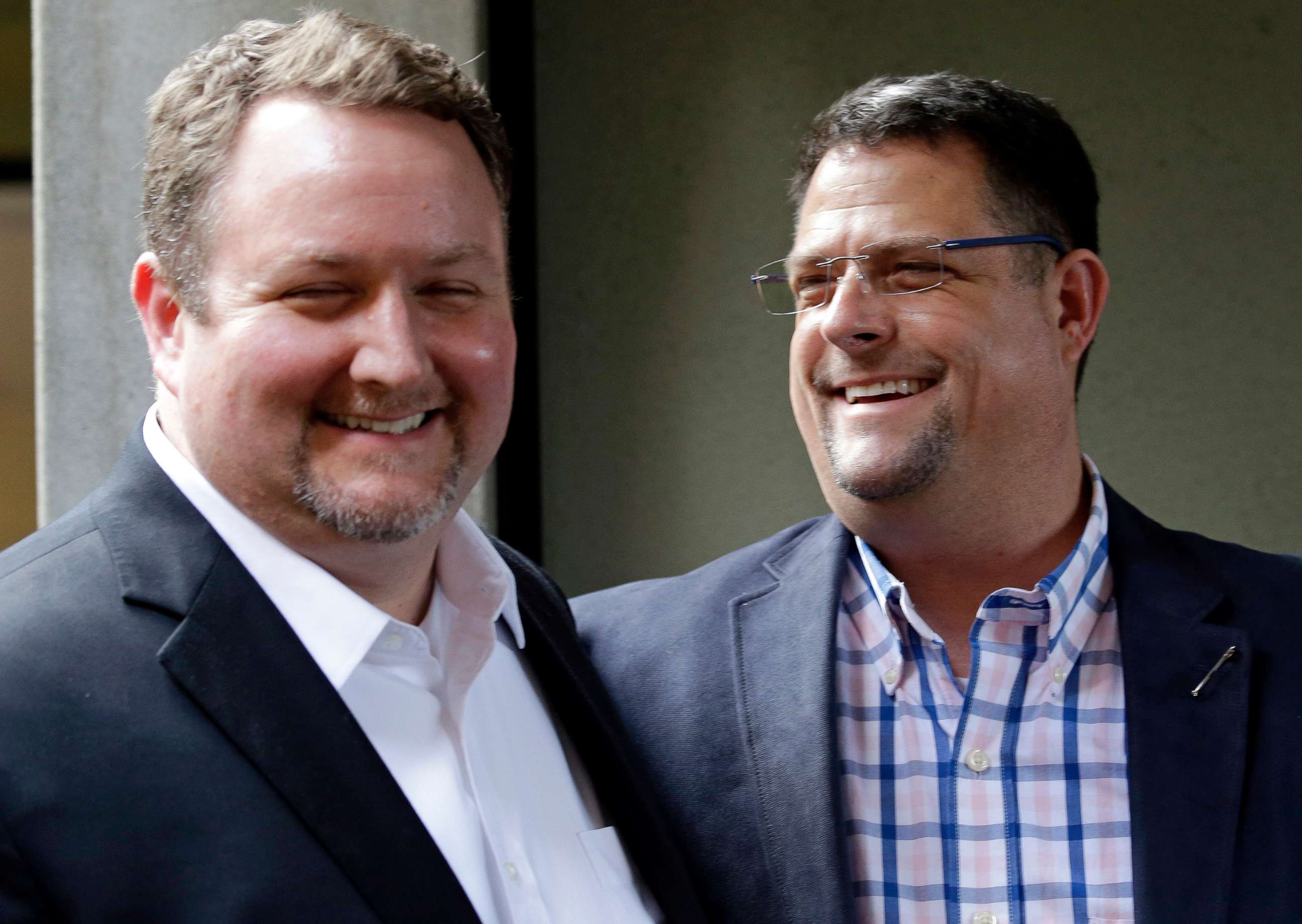 PHOTO: Curt Freed, left, and his husband Robert Ingersoll, the couple who sued florist Barronelle Stutzman for refusing to provide services for their wedding, smile after a hearing before Washington's Supreme Court in Bellevue, Wash., Nov. 15, 2016.