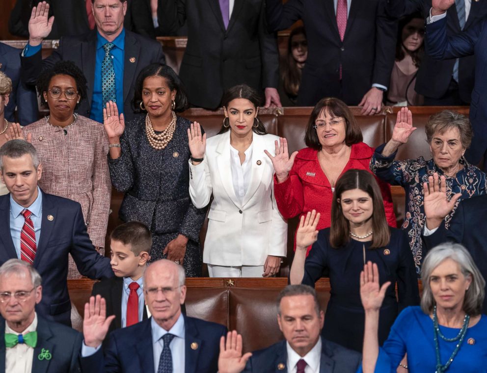 PHOTO: Rep. Alexandria Ocasio-Cortez, center, a freshman Democrat from New York, is flanked by Rep. Jahana Hayes, D-Conn., left, and Rep. Ann McLane Kuster, D-N.H., right, as they are sworn in at the U.S. Capitol, Jan. 3, 2019.