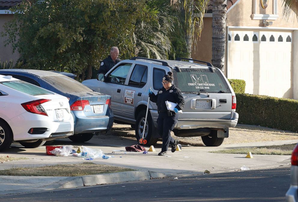 PHOTO: Fresno police investigators work near the driveway where a shooting took place at a house party which involved multiple fatalities and injuries in Fresno, Calif., Nov. 18, 2019.