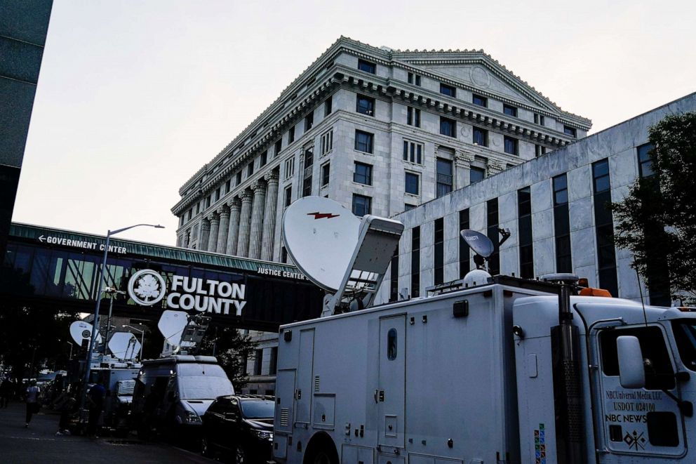 PHOTO: Media vehicles stage outside the Fulton County Courthouse, Monday, Aug. 14, 2023, in Atlanta.