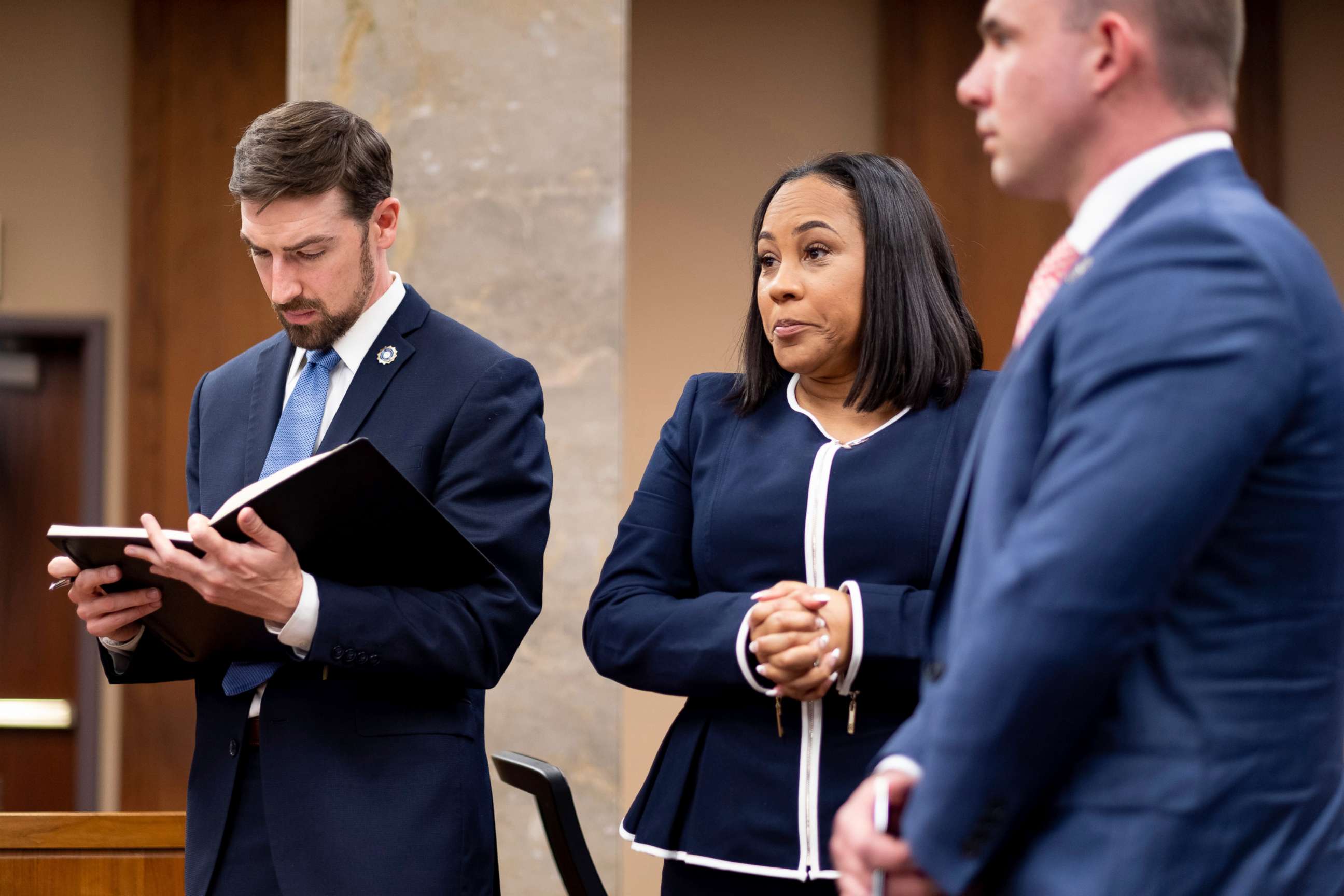 PHOTO: Fulton County District Attorney Fani Willis, center, and members of her team watch as potential jurors are excused during proceedings to seat a special purpose grand jury in Fulton County, Ga., May 2, 2022.
