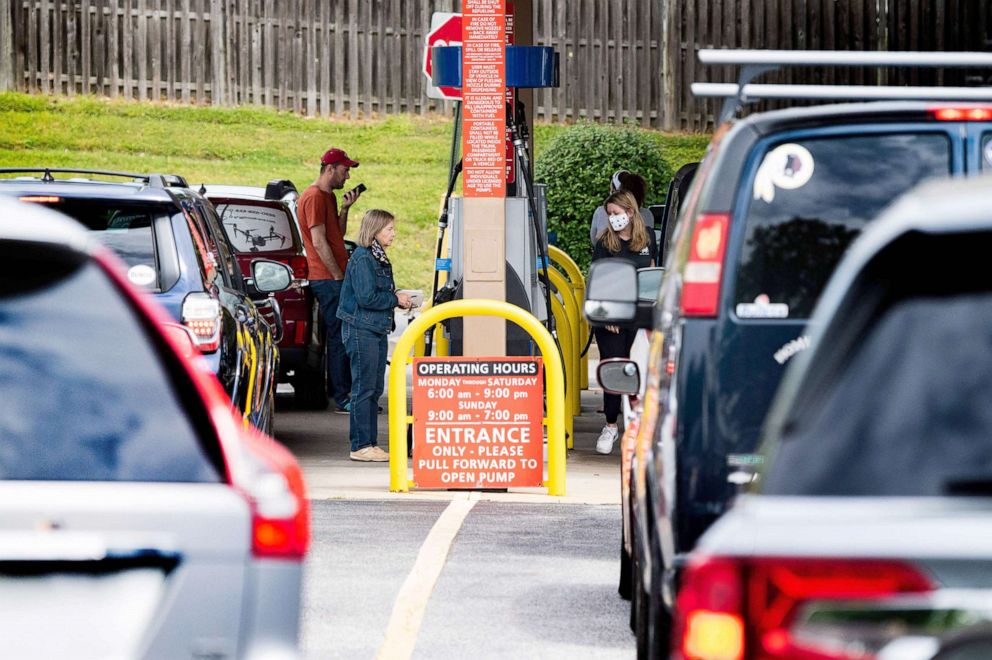 PHOTO: People line up to get gas at a station in Annapolis, Md., May 12, 2021. After a cyber attack caused the shutdown of the Colonial Pipeline, fears of gasoline shortage led to panic buying in several locations. 