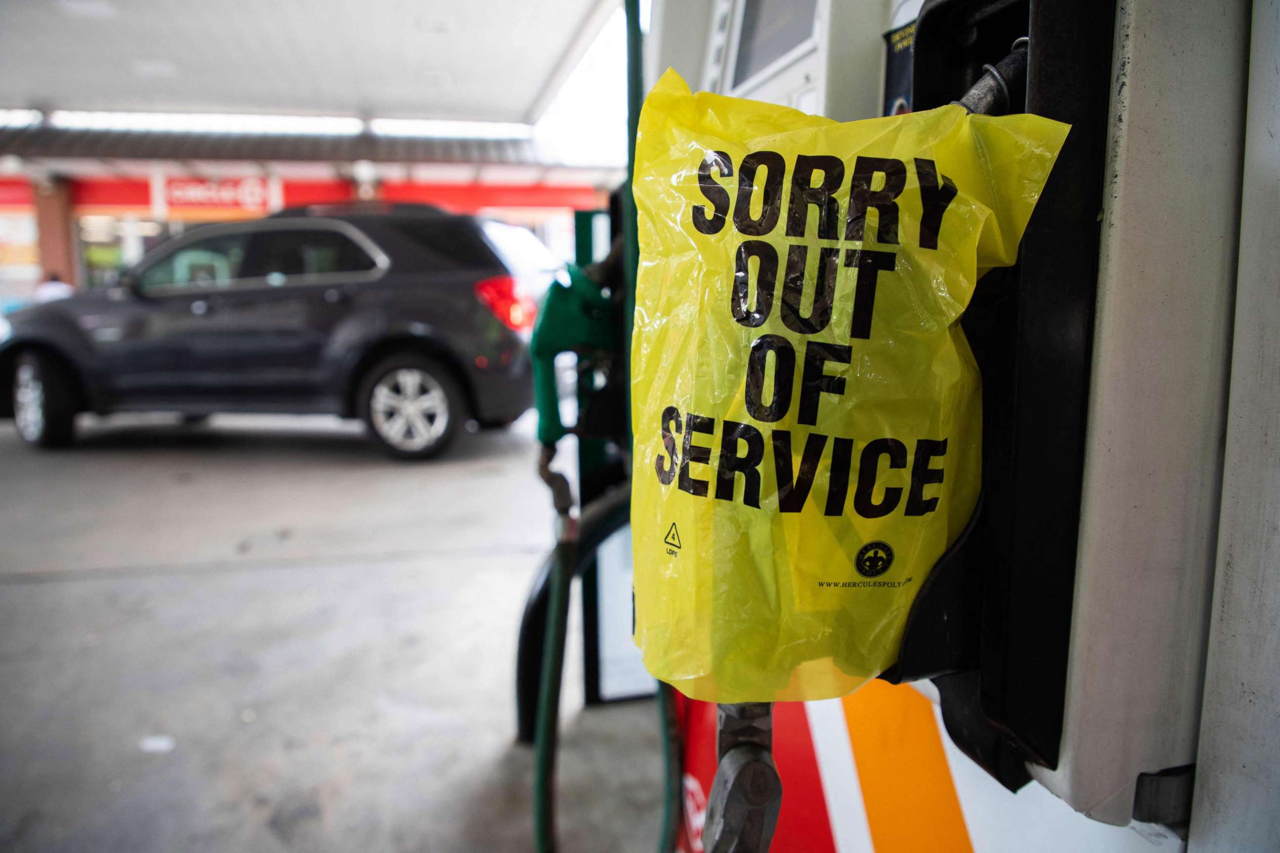 PHOTO: An "Out Of Service" bag covers a gas pump as cars continue line up for the chance to fill their gas tanks at a Circle K near uptown Charlotte, North Carolina on May 11, 2021 following a ransomware attack that shut down the Colonial Pipeline.