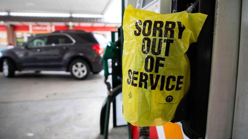 PHOTO: An "Out Of Service" bag covers a gas pump as cars continue line up for the chance to fill their gas tanks at a Circle K near uptown Charlotte, North Carolina on May 11, 2021 following a ransomware attack that shut down the Colonial Pipeline.