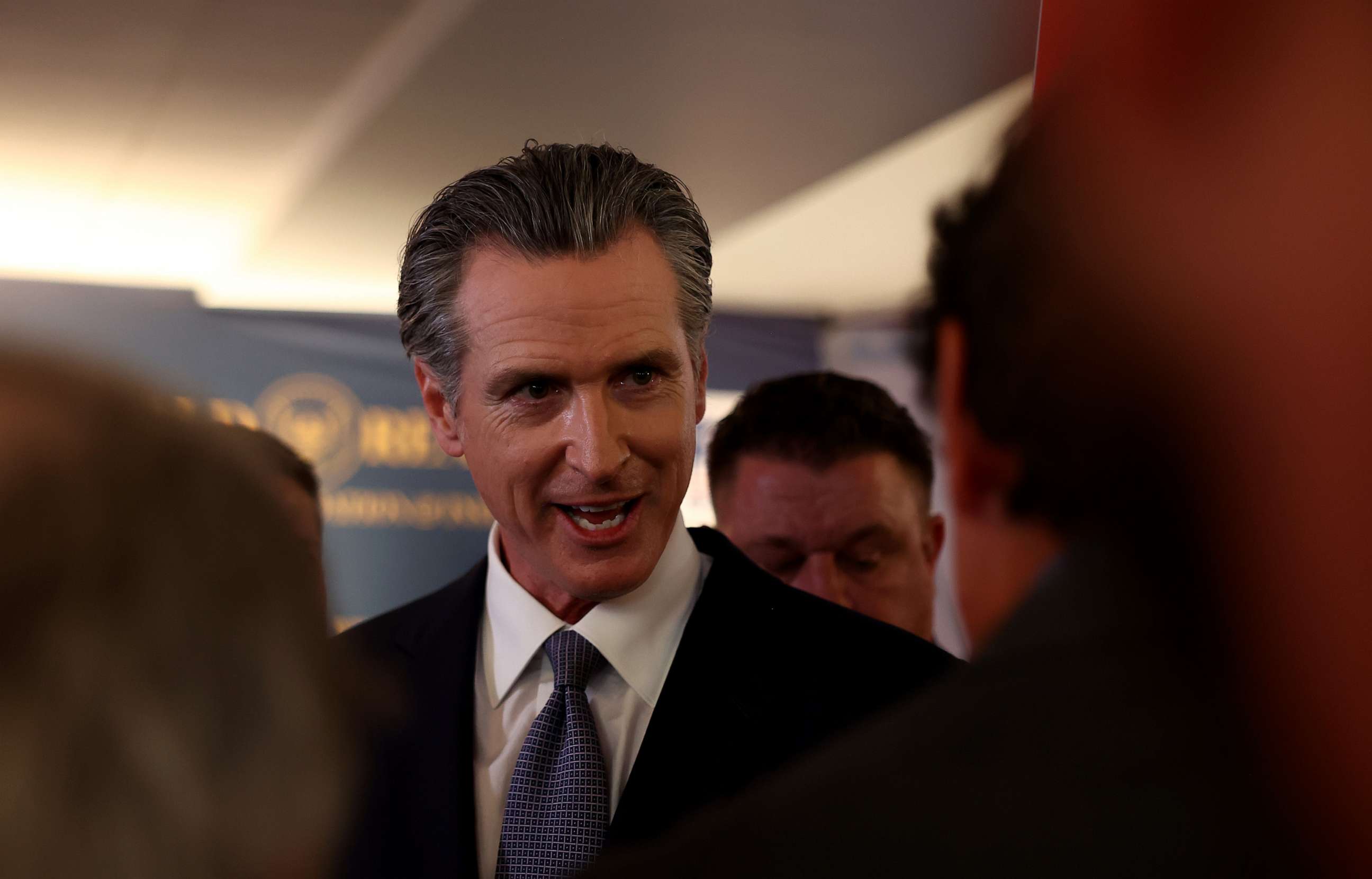 California Gov. Gavin Newsom talks to reporters in the spin room following the FOX Business Republican Primary Debate at the Ronald Reagan Presidential Library on September 27, 2023