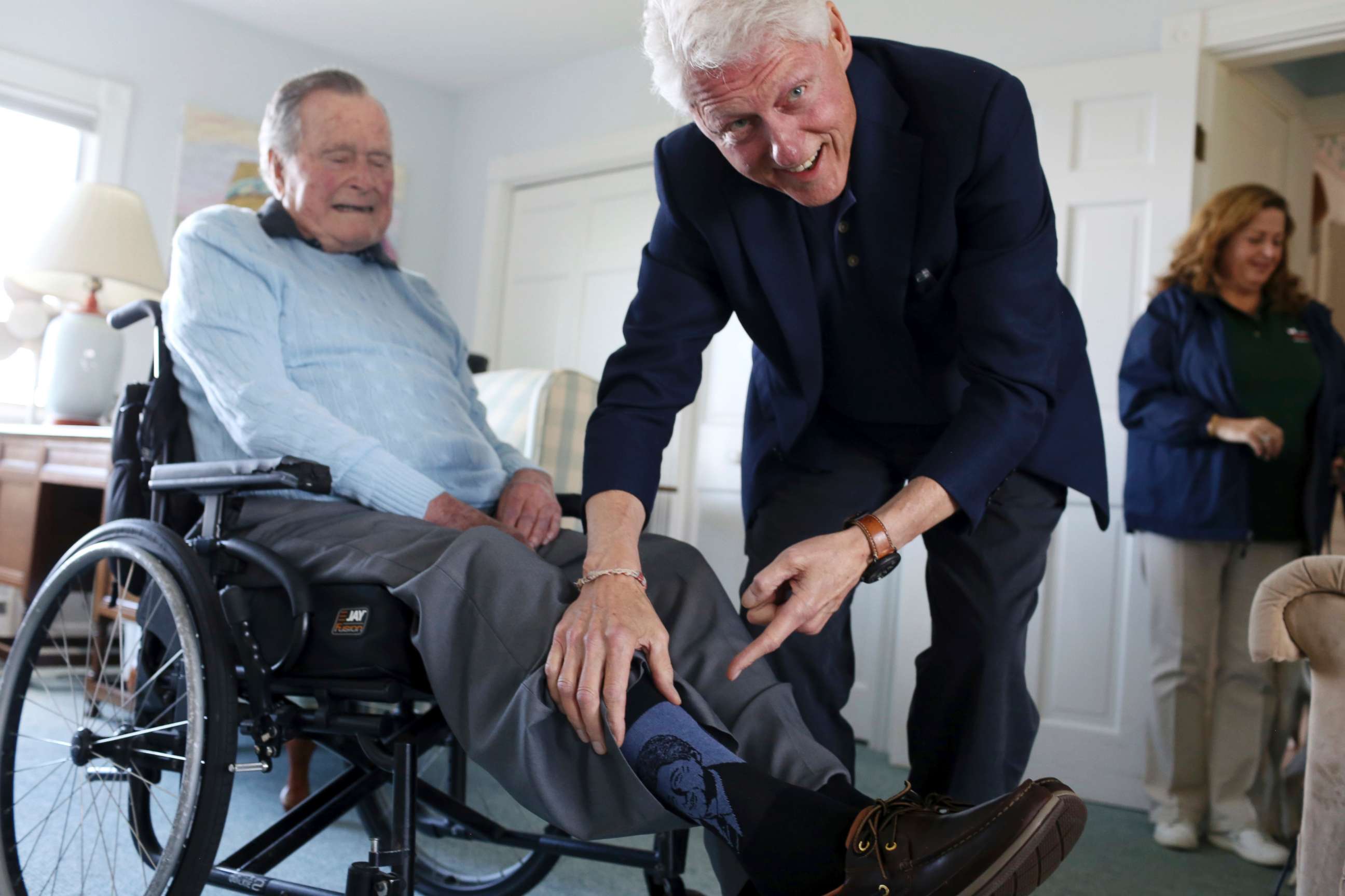 PHOTO: Former President Bill Clinton jokes with former President George H.W. Bush, as Bush shows off a pair of "Bill Clinton socks," while Clinton visits Bush at his home in Kennebunkport, Maine, June 25, 2018.