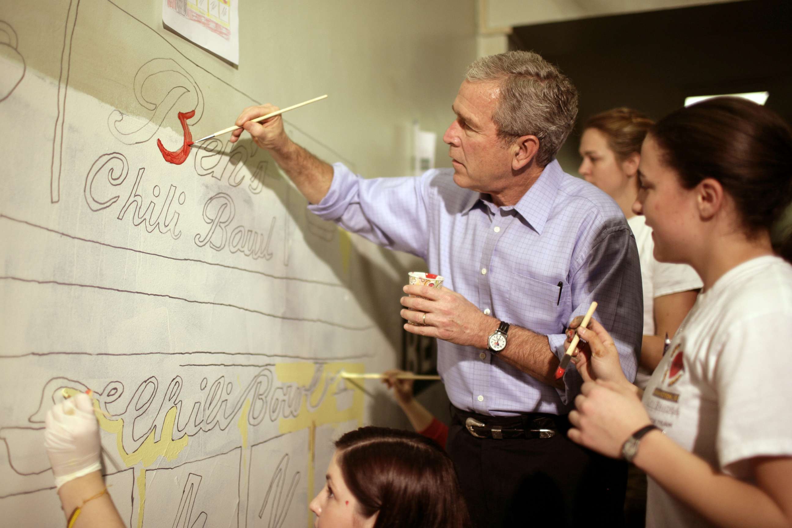 PHOTO: President George W. Bush helps volunteers paint a mural at a high school during the Martin Luther King Jr day of service in Washington, Jan. 15, 2007. 