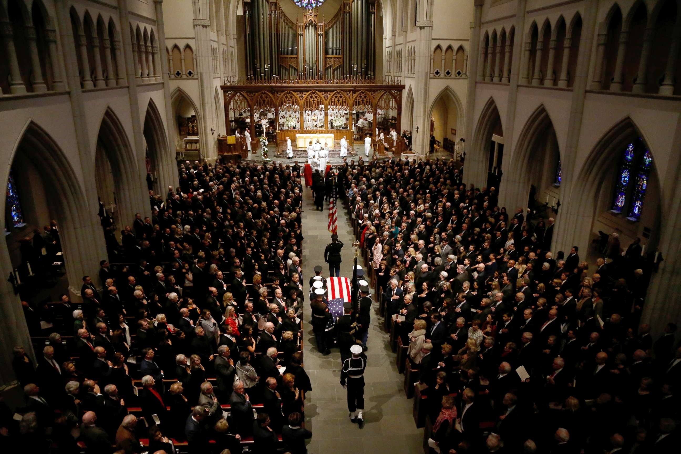 PHOTO: The flag-draped casket of former President George H.W. Bush is carried by a joint services military honor guard into St. Martin's Episcopal Church, Dec. 6, 2018, in Houston.