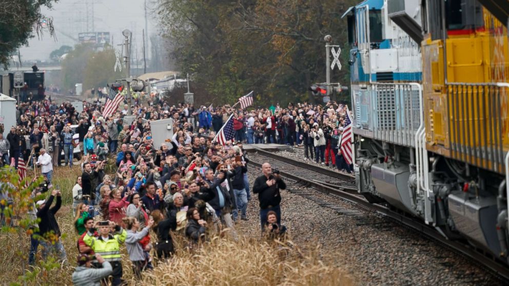 PHOTO: People pay their respects as the train carrying the casket of former President George H.W. Bush passes, Dec. 6, 2018, along the route from Spring to College Station, Texas.