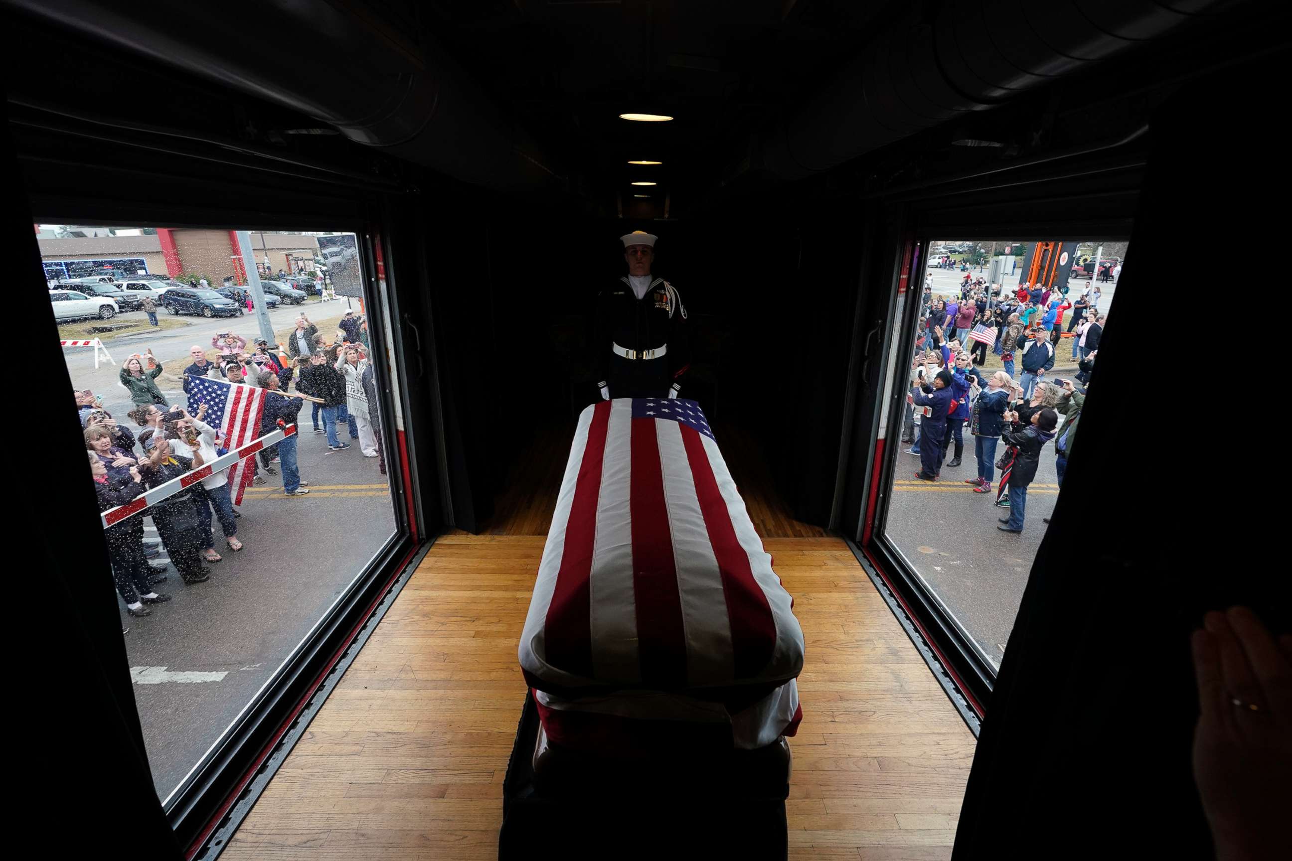 PHOTO: The flag-draped casket of former President George H.W. Bush passes through Magnolia, Texas, Dec. 6, 2018, along the train route from Spring to College Station, Texas.