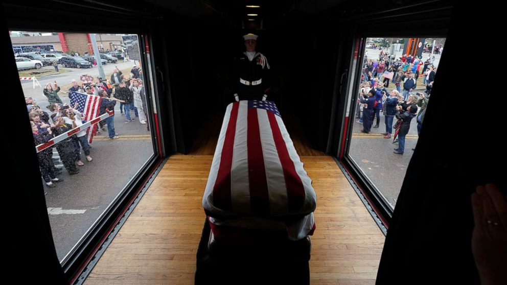 PHOTO: The flag-draped casket of former President George H.W. Bush passes through Magnolia, Texas, Dec. 6, 2018, along the train route from Spring to College Station, Texas.