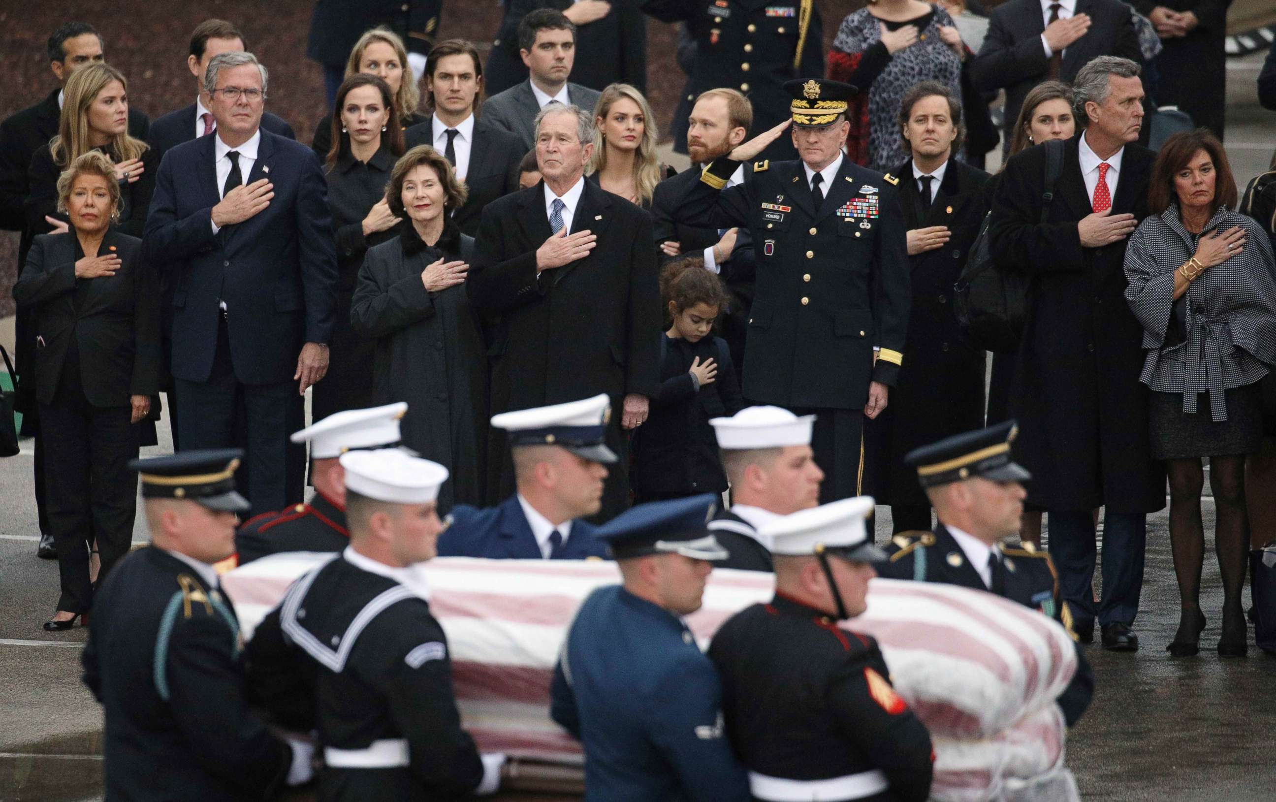 PHOTO: The Bush family looks on as a joint military services honor guard carries the casket for former President George H.W. Bush  from the Union Pacific funeral train at Texas A&M University in College Station, Texas, Dec. 6, 2018.