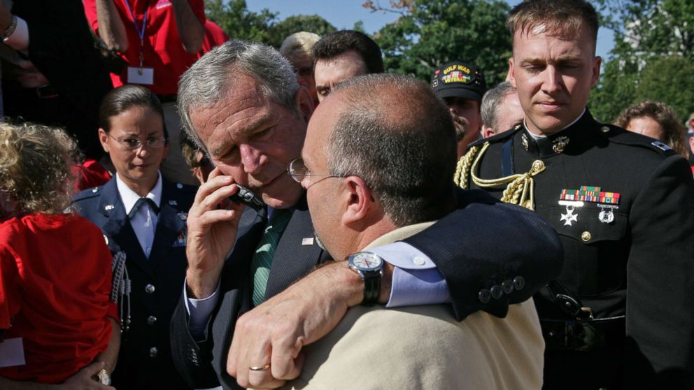 PHOTO: President George W. Bush stands with his arm around Jeff Hallal while speaking on the phone to his wife, Pam Hallal, Sept. 18, 2007 on the South Lawn of the White House.